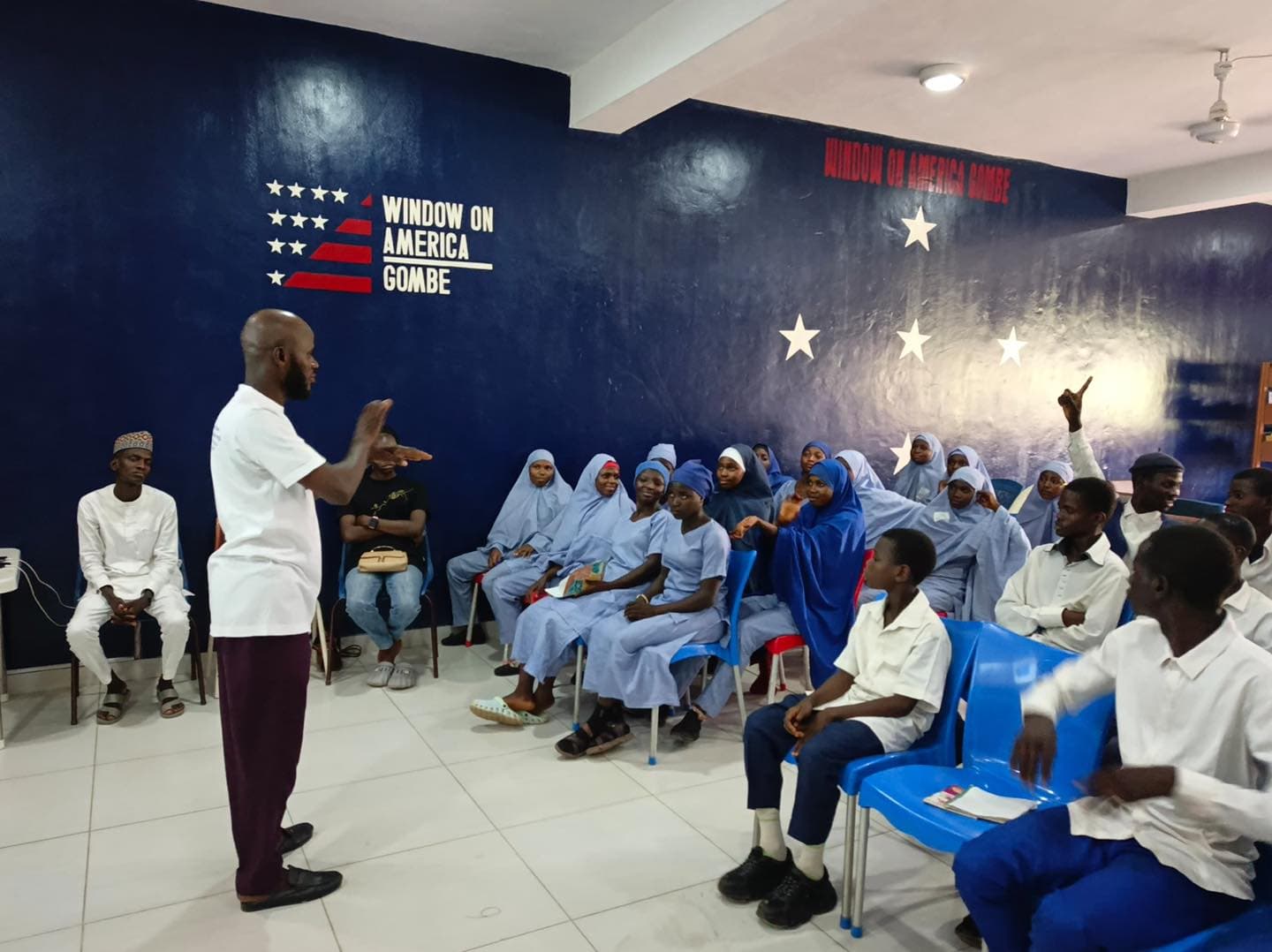 A facilitator signing with Deaf students during a TIDI STEM learning session